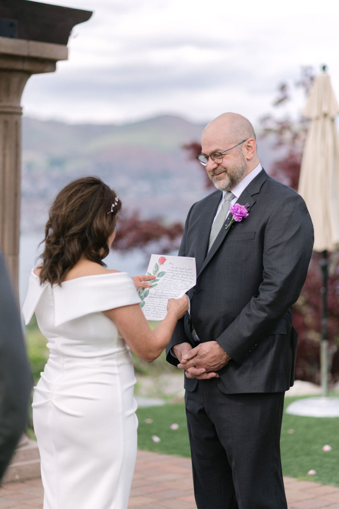 Bride sharing handwritten vows from Rose printed stationery at Lake Chelan
